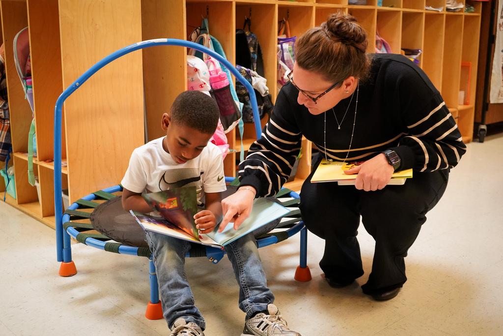 Dr. Wallace reads with student