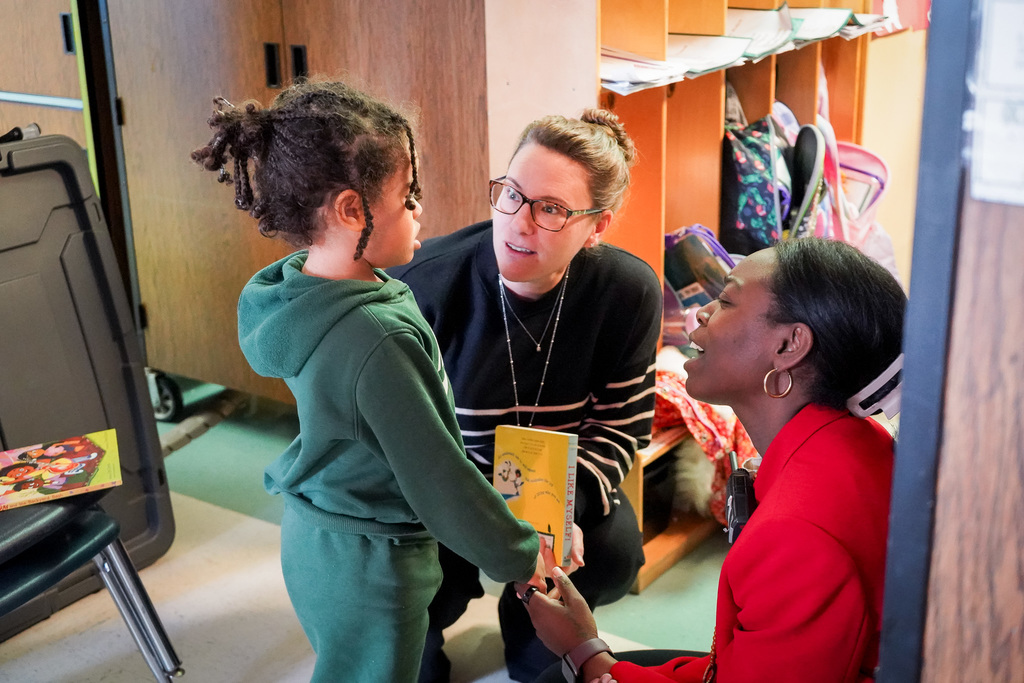 Dr. Wallace and Dr. Jackson talk to young student