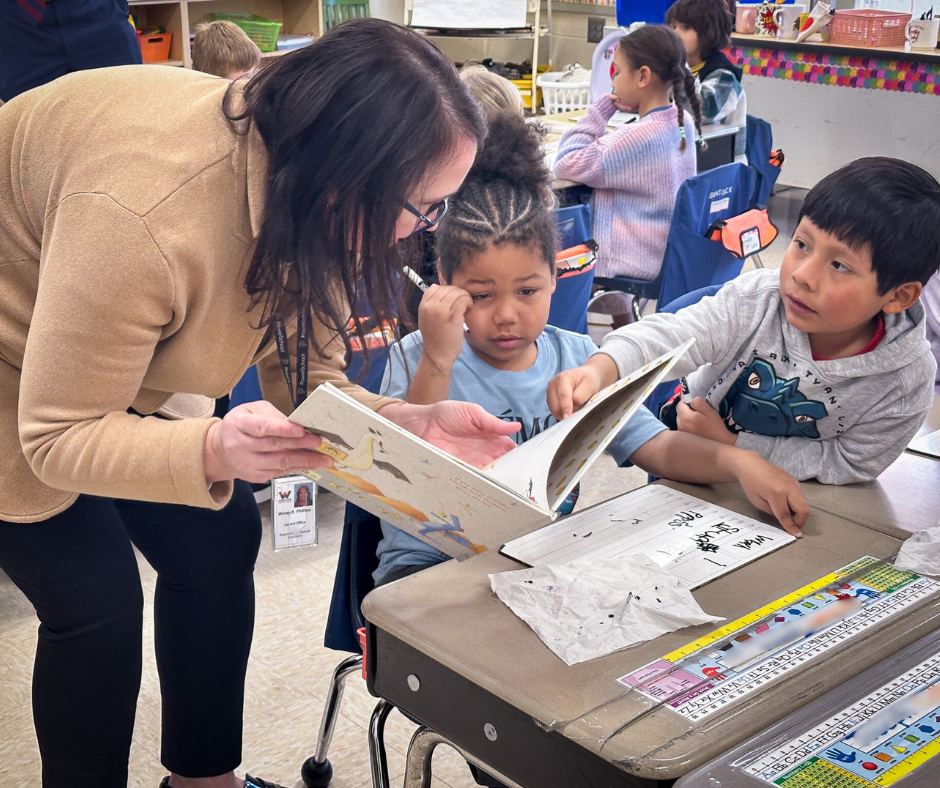 CO leader presenting book to child