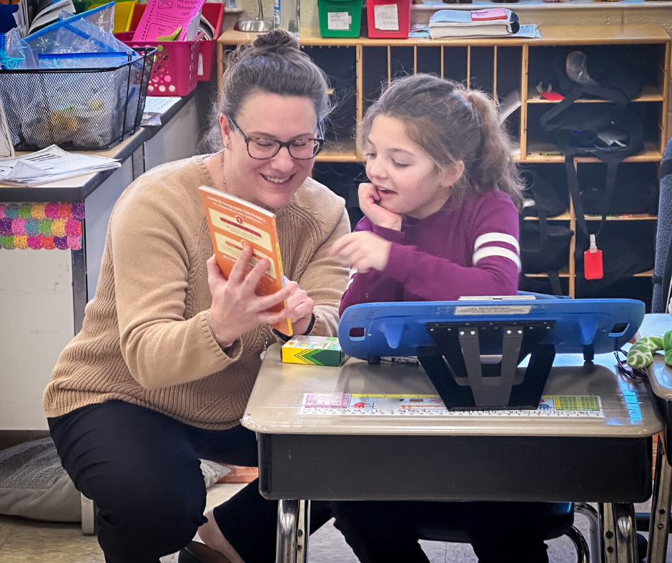 CO leader presenting book to child