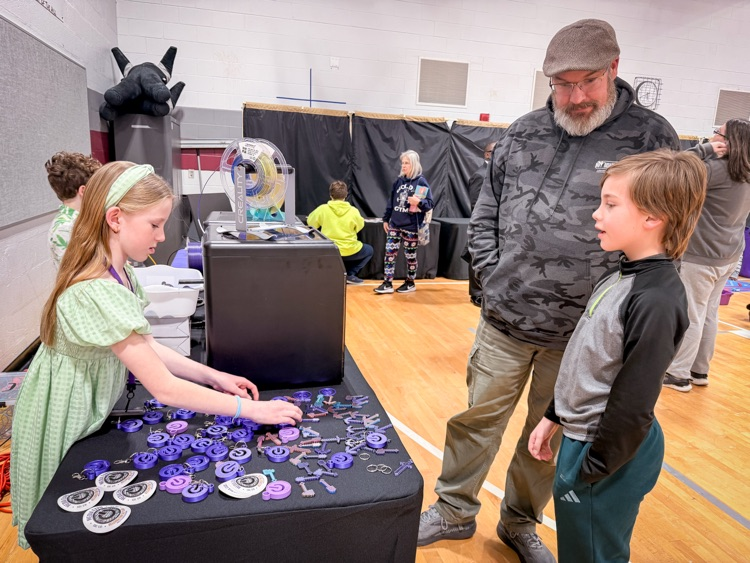 students talking to adult about media project
