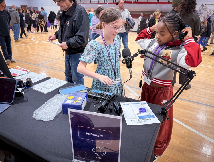 two students listening to a podcast