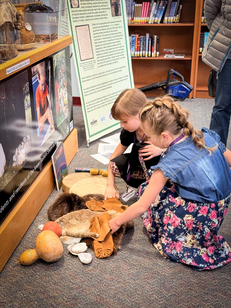 students on the floor with therapy pets
