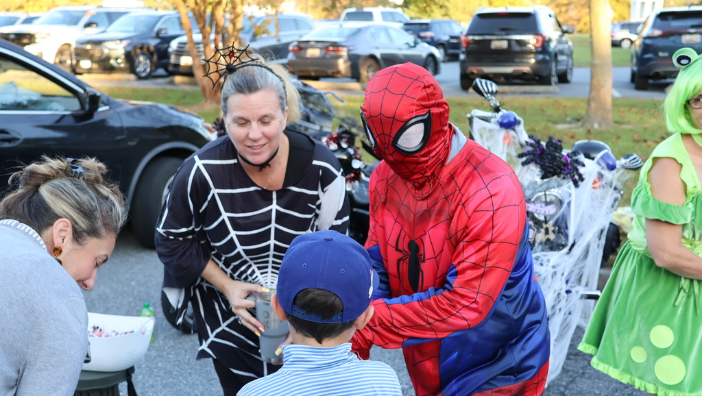 adult handing out candy- trunk or treat