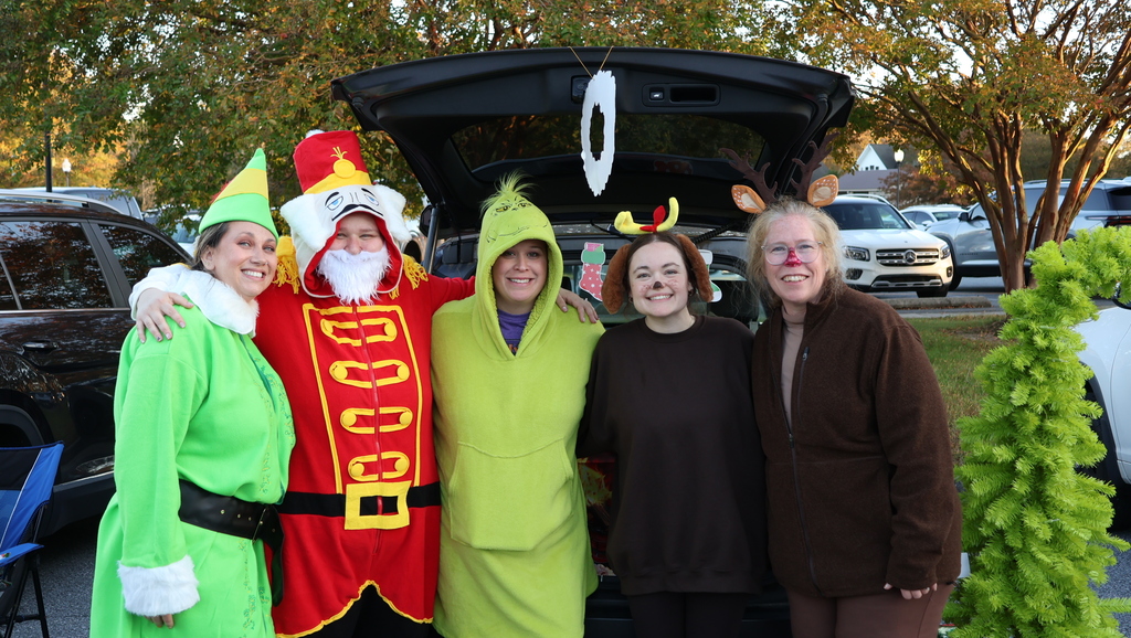 5 adults outside  in halloween costumes