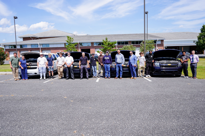Students Pose with Donated Vehicles