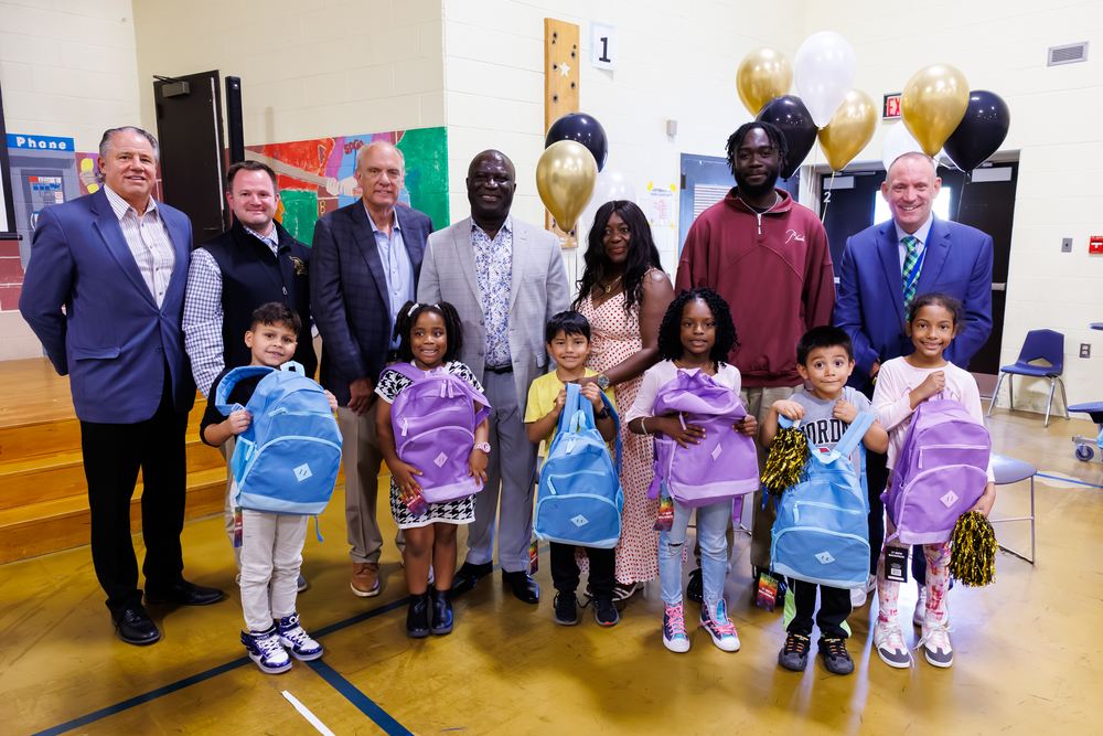 Students from Chandler Elementary Community School proudly display new backpacks donated by New Orleans Saints cornerback Isaac Yiadom, joined by Mayor Joseph M. Petty, Superintendent Brian E. Allen, Doherty Principal John Staley, Assistant Principal Edward Capstick, and members of the Yiadom family. (Kyle Prudhomme/WPS)
