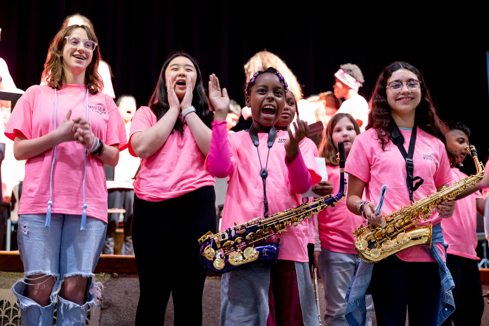 students with musical instruments on stage