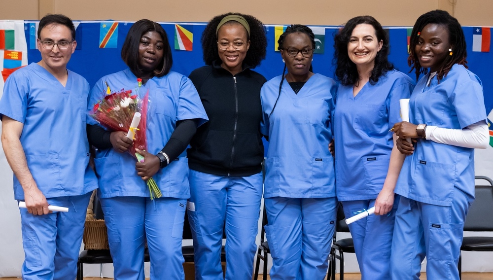 Six adults wearing nursing scrubs