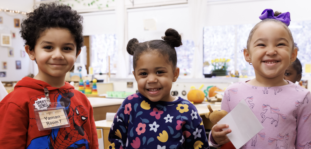 Three pre-school age children in a classroom