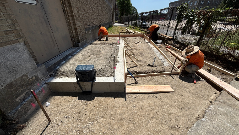 Construction workers build an ADA-accessible ramp at The Fanning Building as part of WPS facility improvements conducted over the summer. 