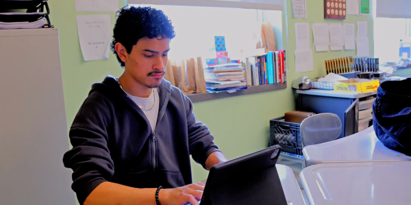 Erick Elena Villatoro works on a computer in a classroom setting.
