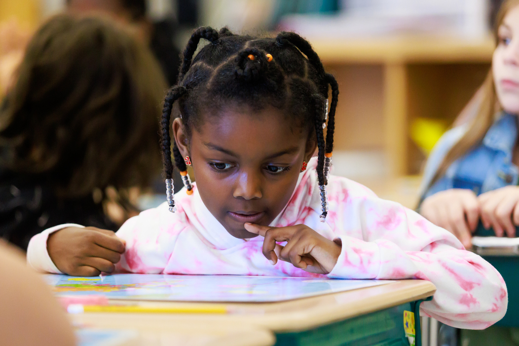 A student examines a world map.
