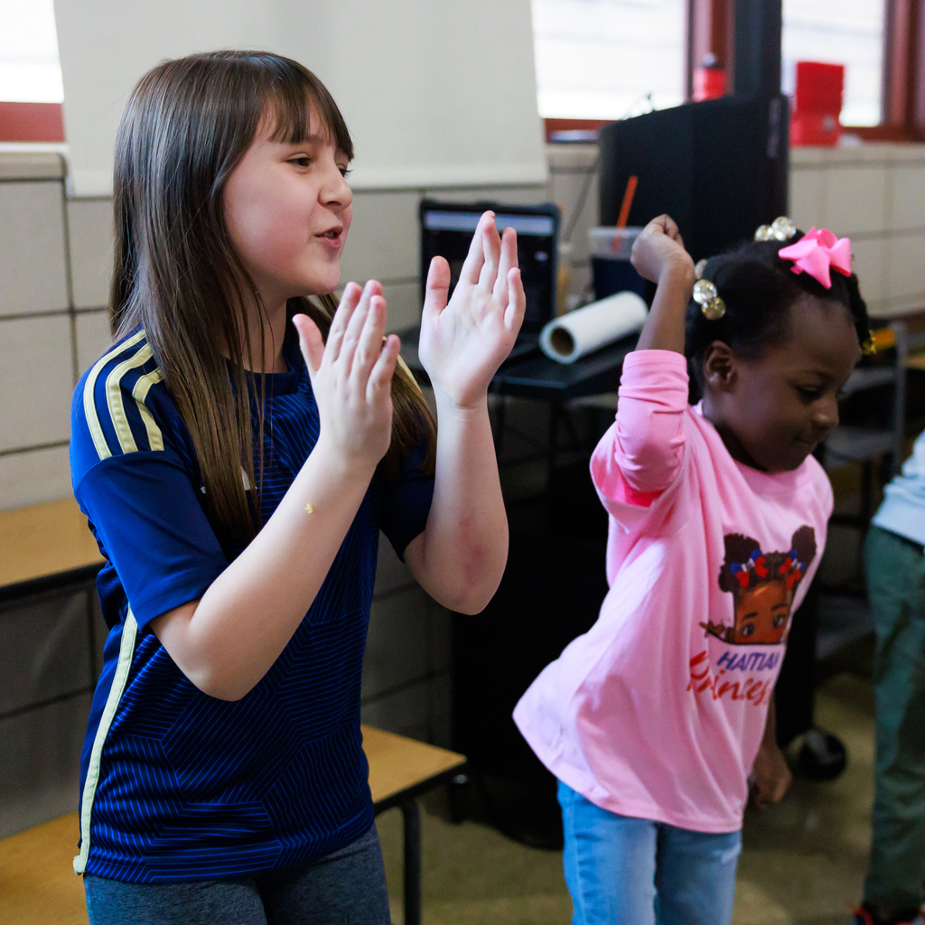 A student dances during "Turn Up Tuesday" in the lunchroom.