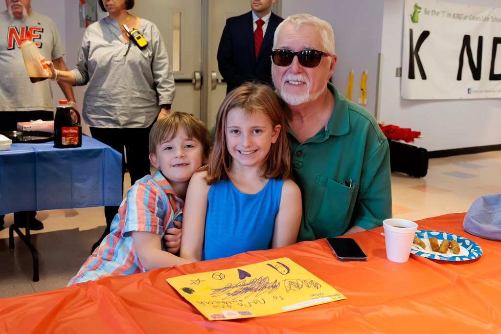 Two students with their grandpa.