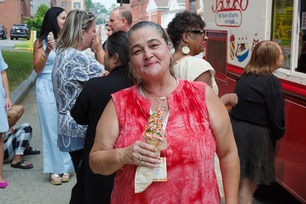 WPS staff smiles with a ice cream cone.