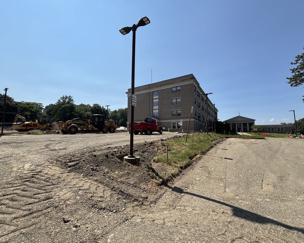 A parking lot with construction vehicles parked.