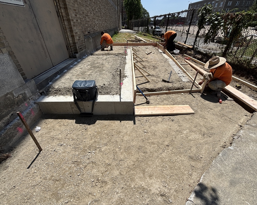 Workers conduct upgrades to an ADA-accessible ramp at The Fanning Building.