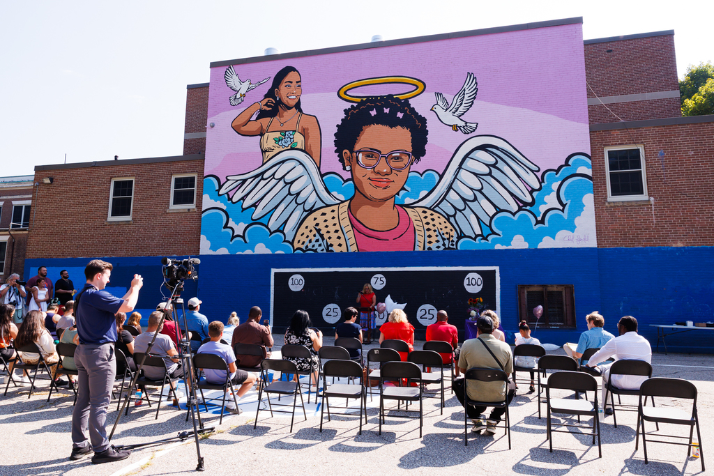 Members of the community gather in front of the new mural in remembrance of Zella and Chasity Nunez. 