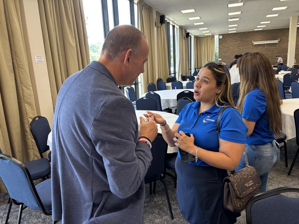 Superintendent Brian Allen speaks with a woman from a community agency