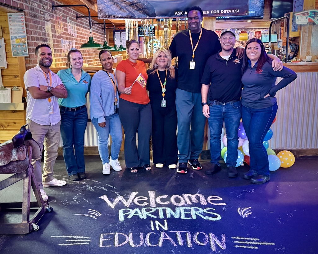 Burncoat Quadrant Wraparound Coordinators stand with staff at Texas Roadhouse.