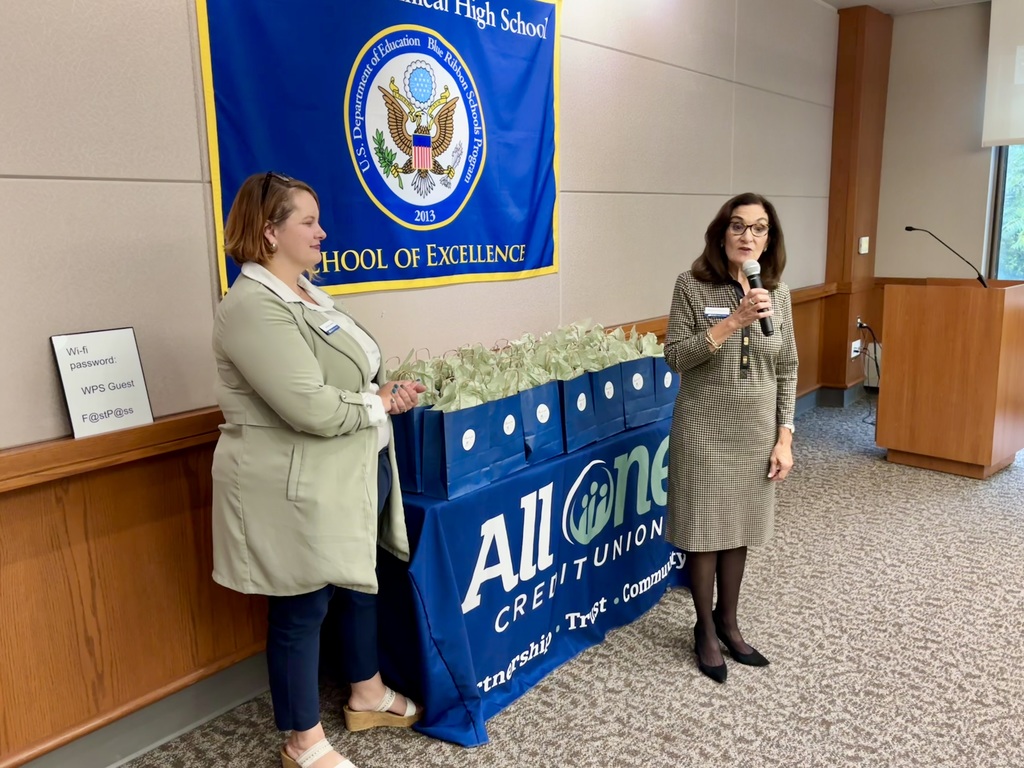 Two bank officials address a room