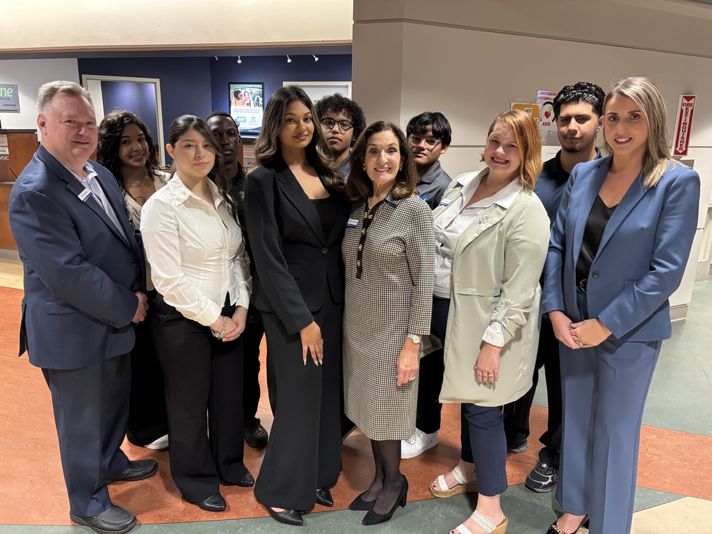 Students and credit union staff pose for a photo