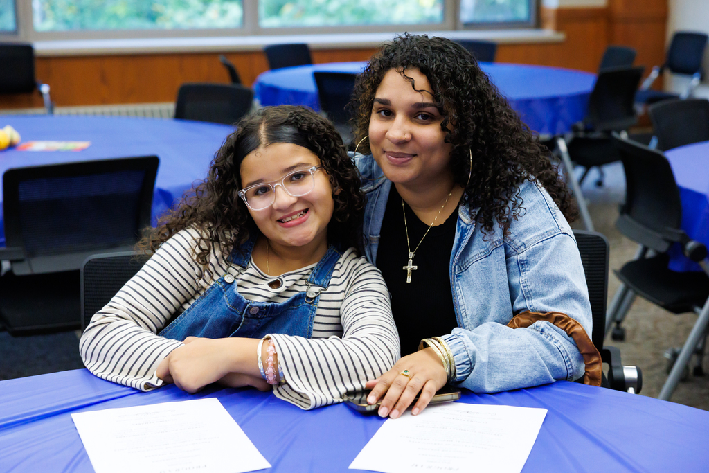A mother and daughter smile for a photo.
