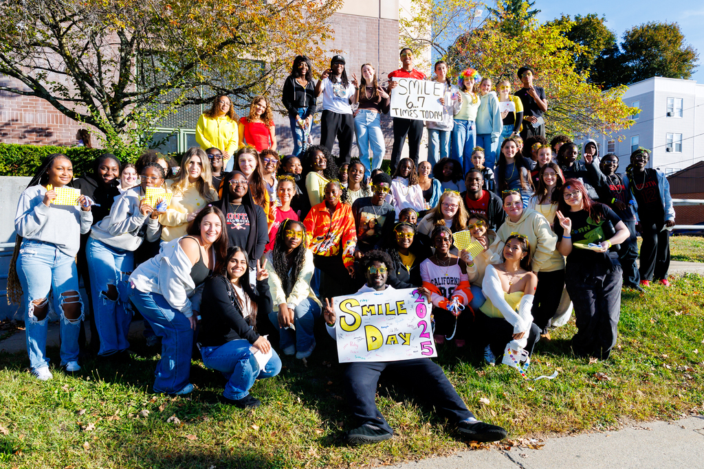 Students at South High take a group photo, holding up handmade signs to celebrate World Smile Day.