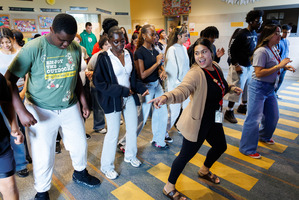 Students and teachers dance during a lesson honoring Hispanic Heritage Month.