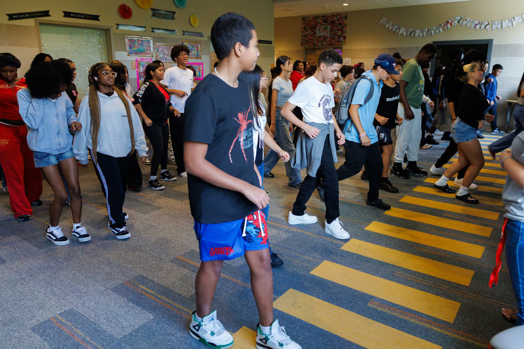 Students and teachers dance during a lesson honoring Hispanic Heritage Month.