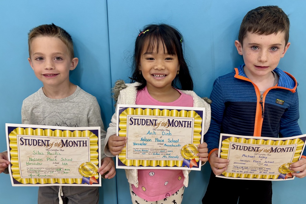 Three smiling students proudly display their 'Student of the Month' certificates.