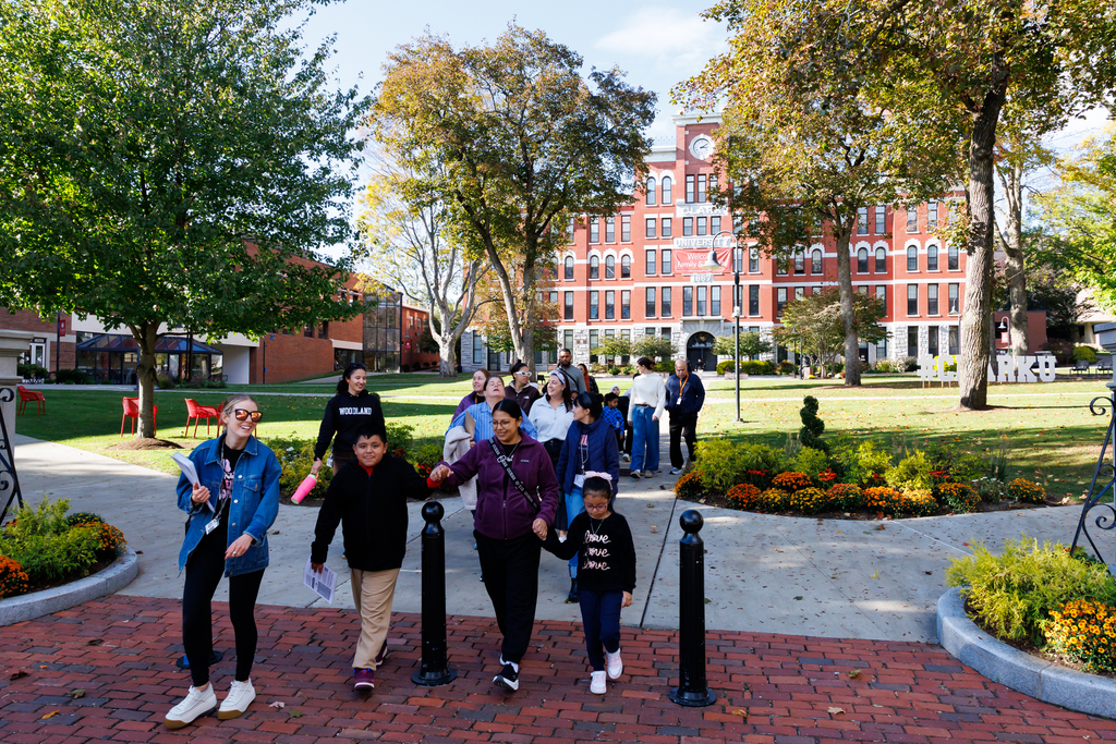 Students, family and staff of Woodland Academy walk through the campus of Clark University.