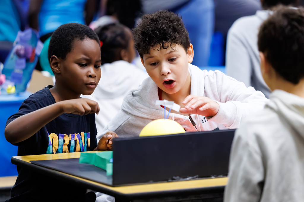 Two students engage with a project during a STEAM Showcase at Lake View.