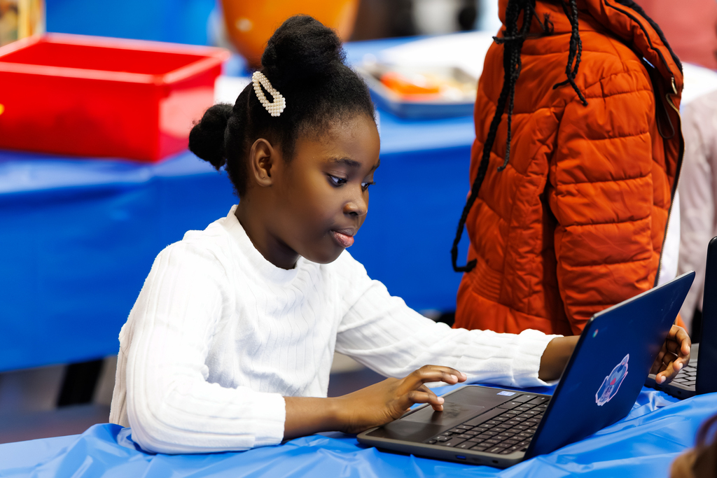 A student interacts with an activity on their laptop during a STEAM Showcase at Lake View.