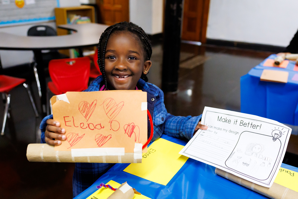A young student holds up their project during a STEAM Showcase at Lake View.