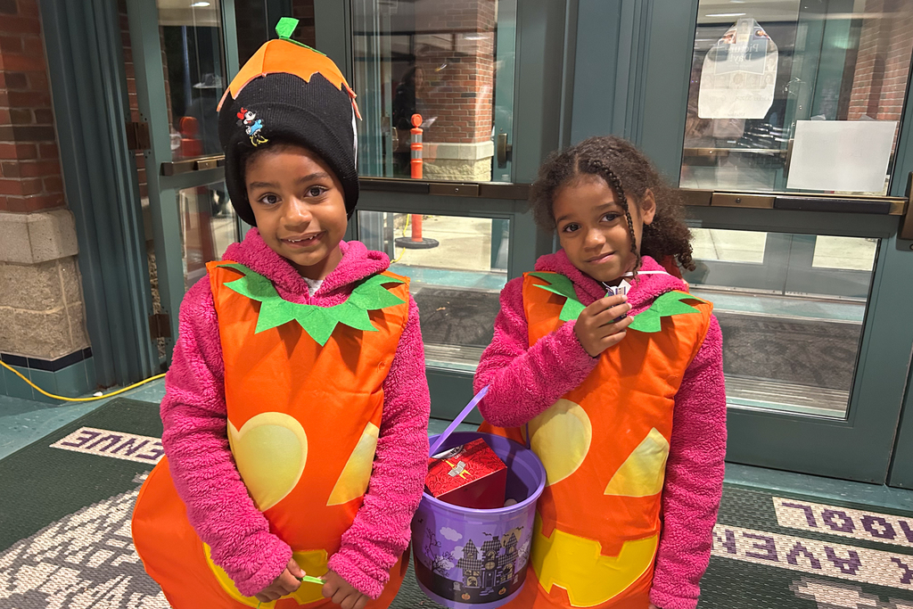 Two students dressed as pumpkins during a Trunk or Treat.
