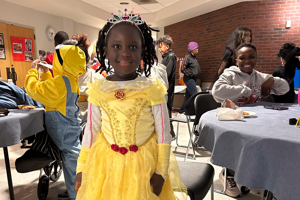 A young student dressed as a Queen during a Trunk or Treat.