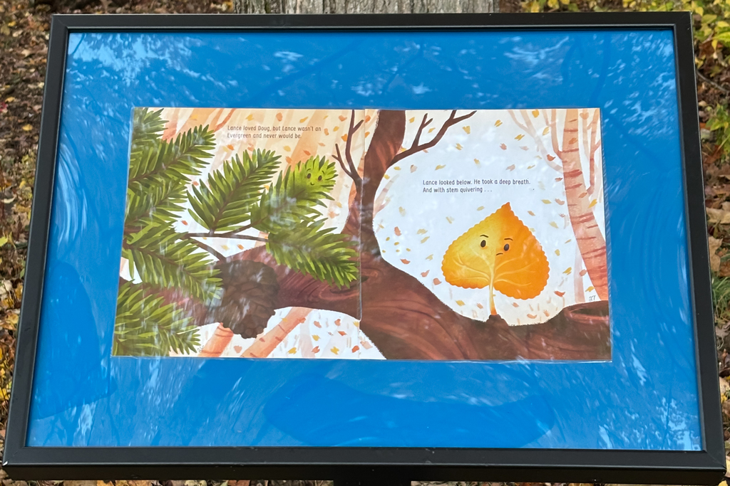 A framed illustration depicts a leaf looking down, with text from a children's book.