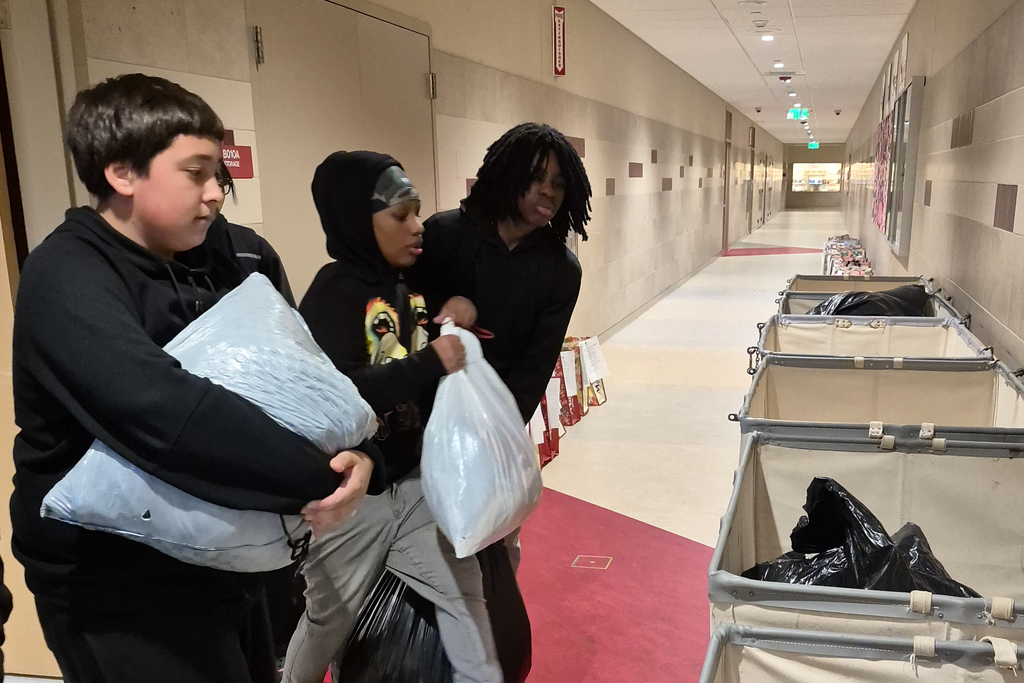 Students sort through clothes for a clothing donation.
