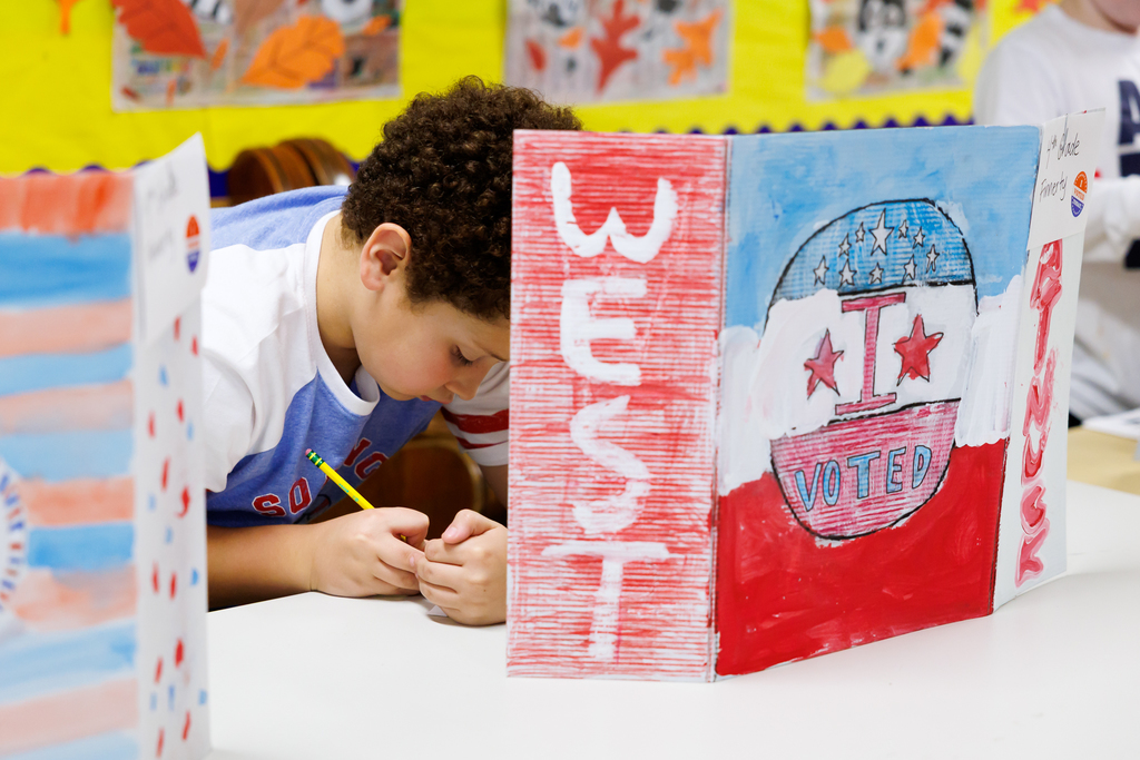 A student votes during the sixth grade elections.