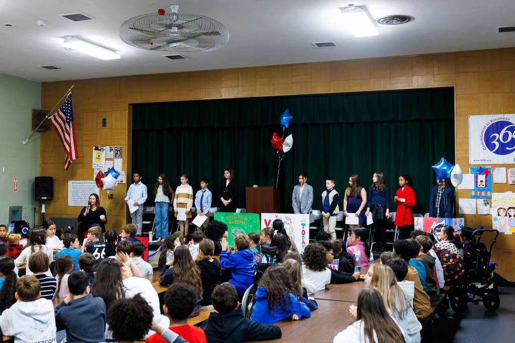 The canidates stand on stage following their speeches during the sixth grade elections.