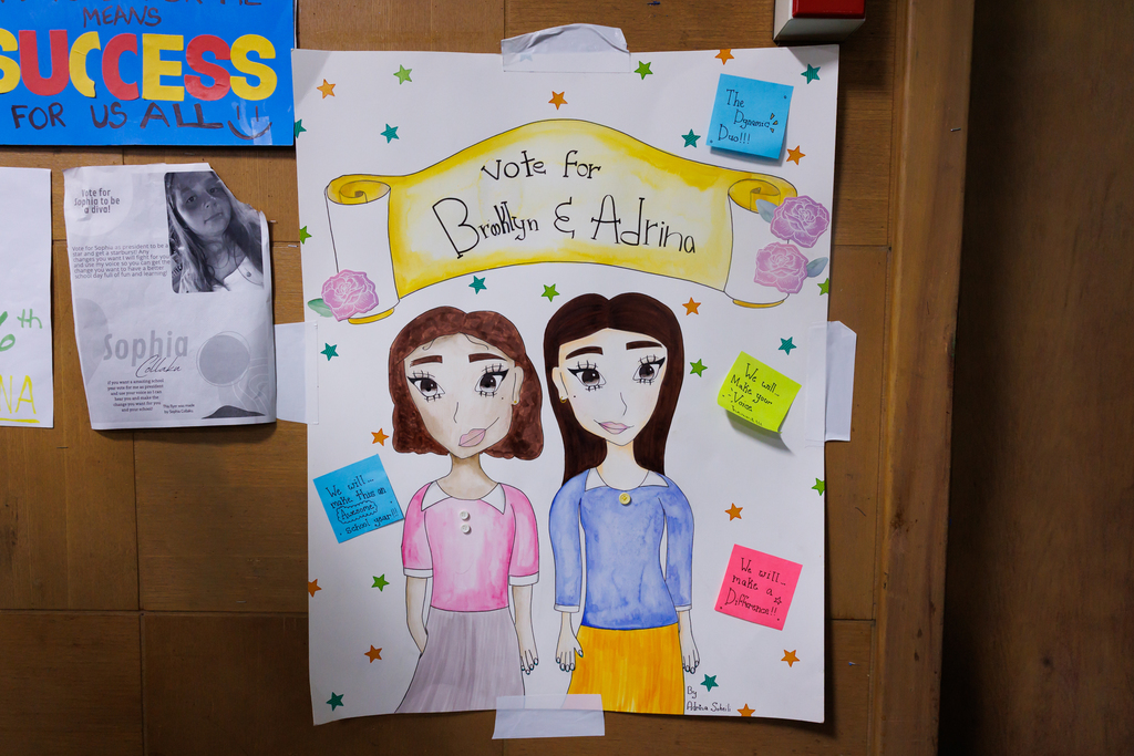 A colorful poster that says "Vote for Brooklyn & Adrina."