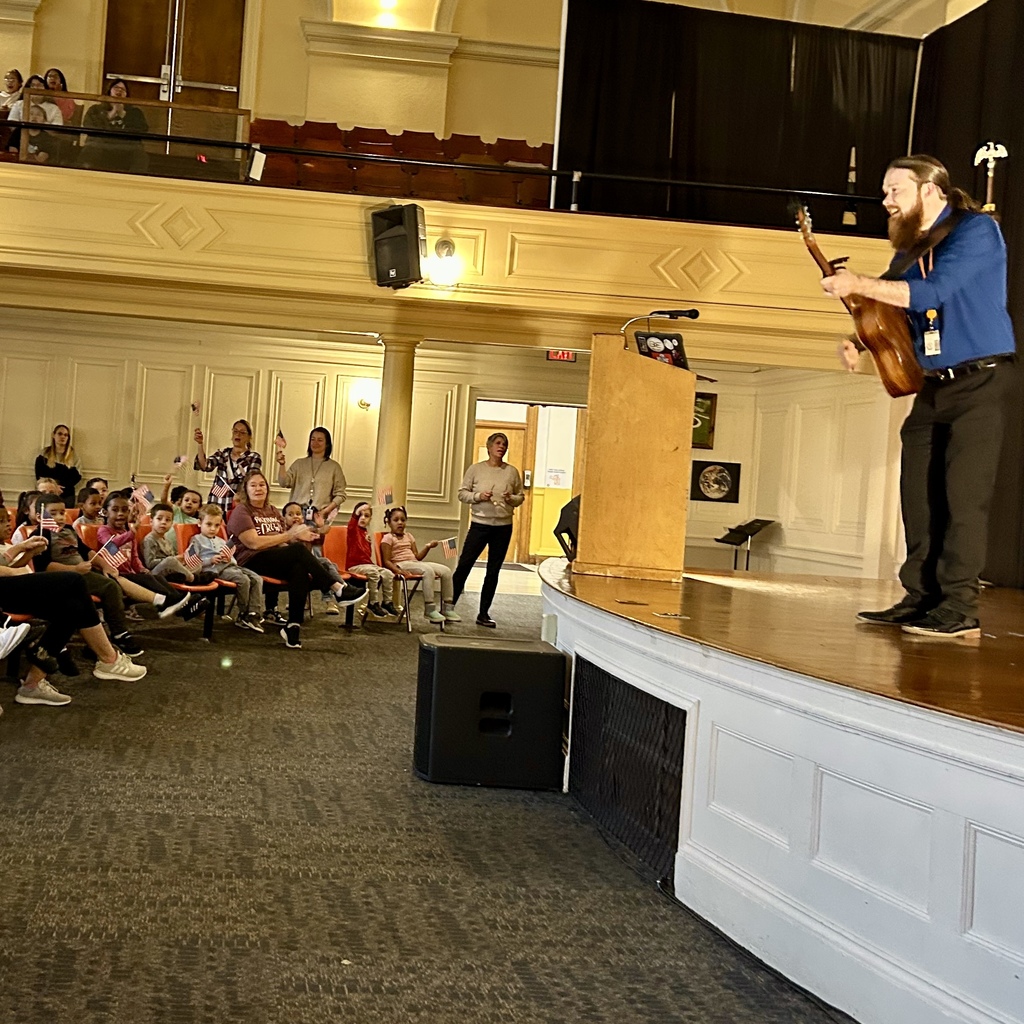 A young woman speaks at a podium, microphone in front of her.