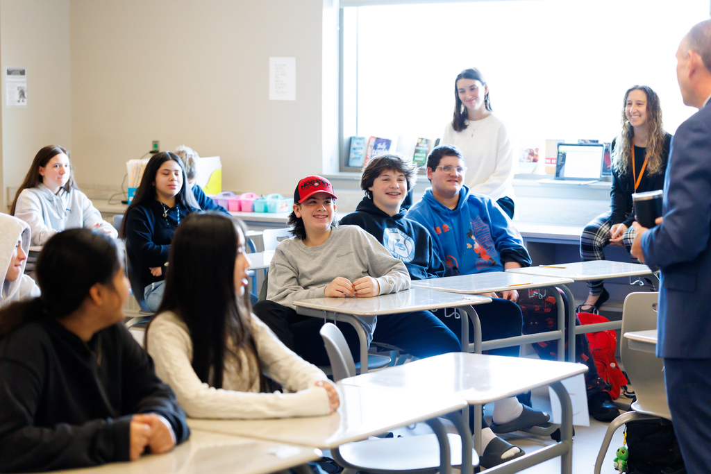 Students focused on a speaker during a Career Day presentation.