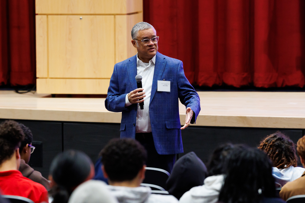 A presenter speaks to students during a Career Day event.