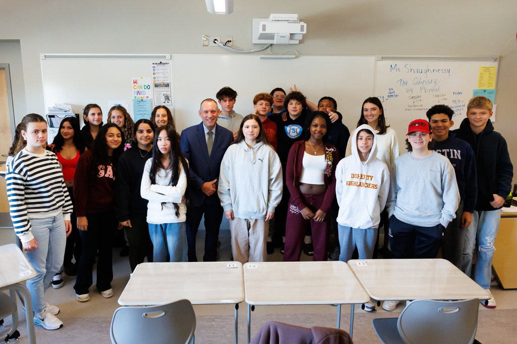 A large group of students stand with Superintendent Brian Allen.
