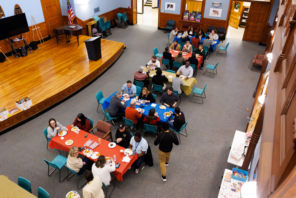Staff in the Durkin Administration Building eat lunch together during a Thanksgiving potluck.