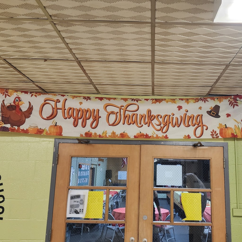 A 'Happy Thanksgiving' banner hangs above a set of wooden doors.