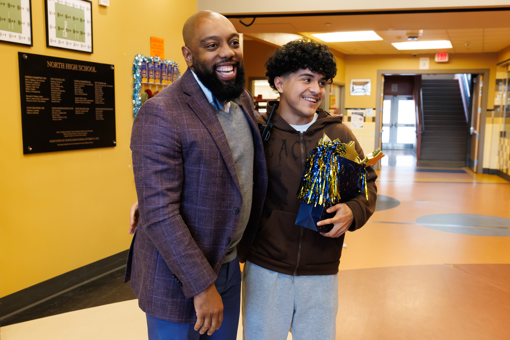 North High Principal Sam FanFan smiles alongside 11th grader Ricardo Bonilla.